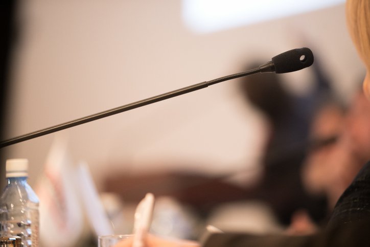 Wooden table in court of law with microphone and gavel