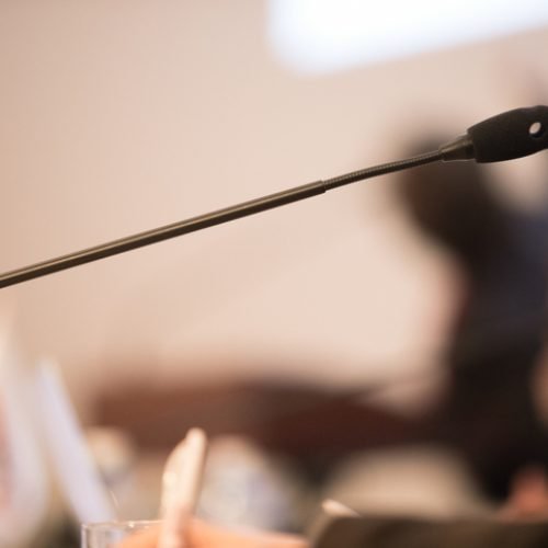 Wooden table in court of law with microphone and gavel