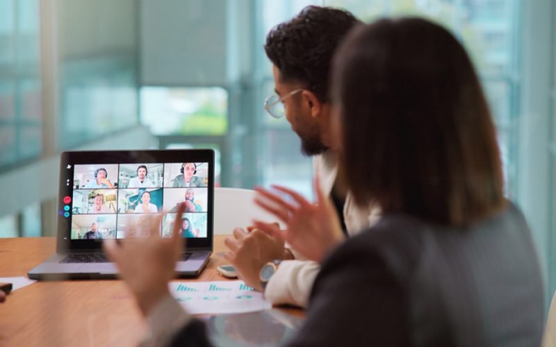 Conversation, laptop screen and video call with business people in boardroom for online planning. Communication, computer and virtual meeting with employee team in office for development webinar