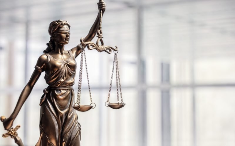 Legal and law concept statue of Lady Justice with scales of justice and office background