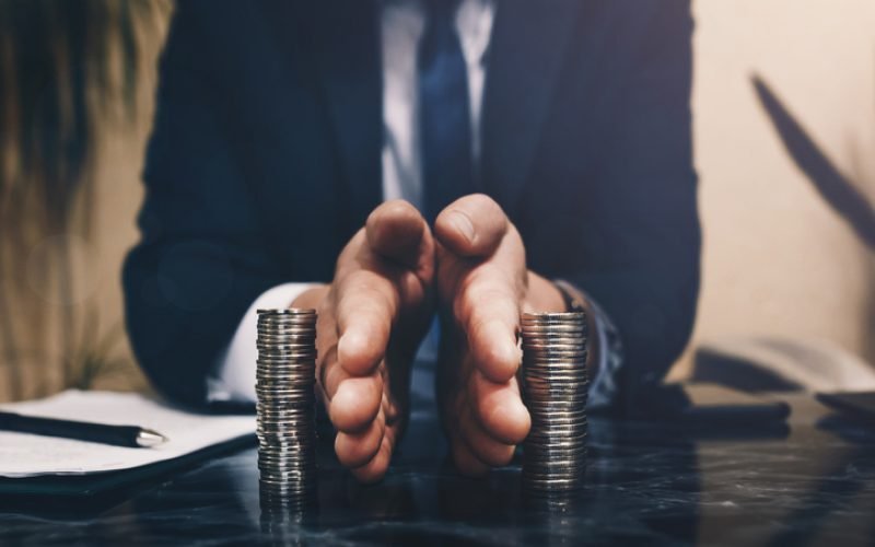 Businessman separates stack coins. Concept of  saving and investing.  Property division. Divorce and legal services