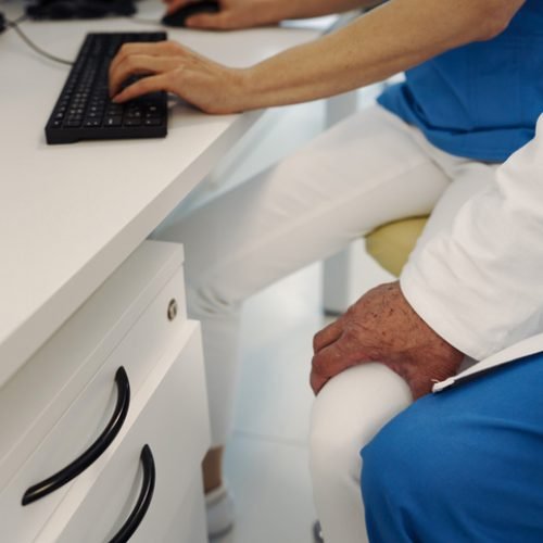 Inappropriate behavior of doctor, holding nurse by thigh. Workplace harassment in hospital.