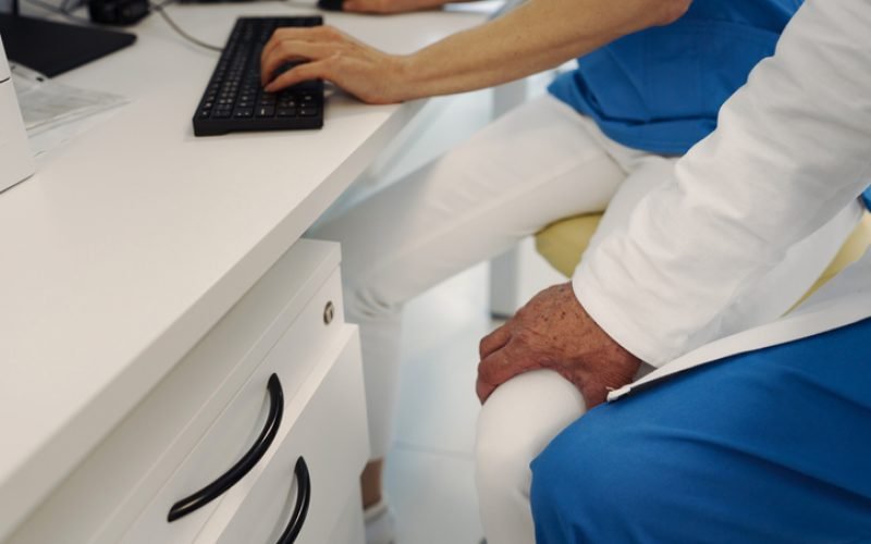 Inappropriate behavior of doctor, holding nurse by thigh. Workplace harassment in hospital.
