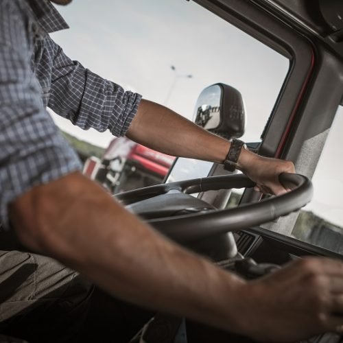 Transportation and Automotive Industry. Commercial Driving. Caucasian Truck Behind the Wheel.