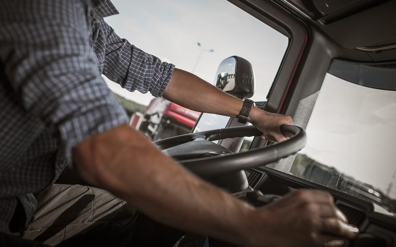 Transportation and Automotive Industry. Commercial Driving. Caucasian Truck Behind the Wheel.