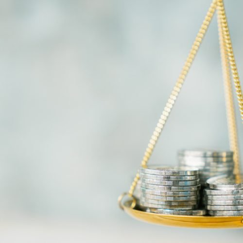 Coins stack with balance scale. Money management, financial plan, time value of money, business idea and Creative ideas for saving money concept.