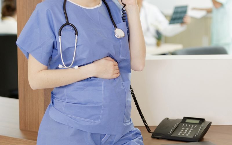 pregnant nurse is working in the office