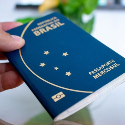 Holding Brazilian passport with hand.