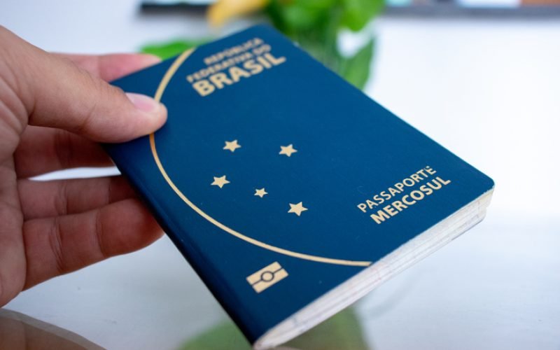 Holding Brazilian passport with hand.