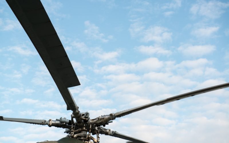 Helicopter rotor on bright sunny day with blue skies