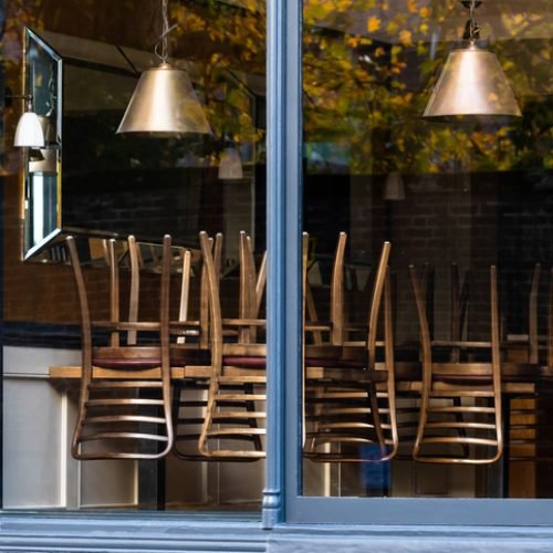 Chairs on the tables of a restaurant forced to close during lockdown to control COVID-19 pandemic, Cambridge, UK