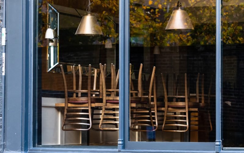 Chairs on the tables of a restaurant forced to close during lockdown to control COVID-19 pandemic, Cambridge, UK