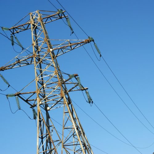 high-voltage line electrified  on background blue sky
