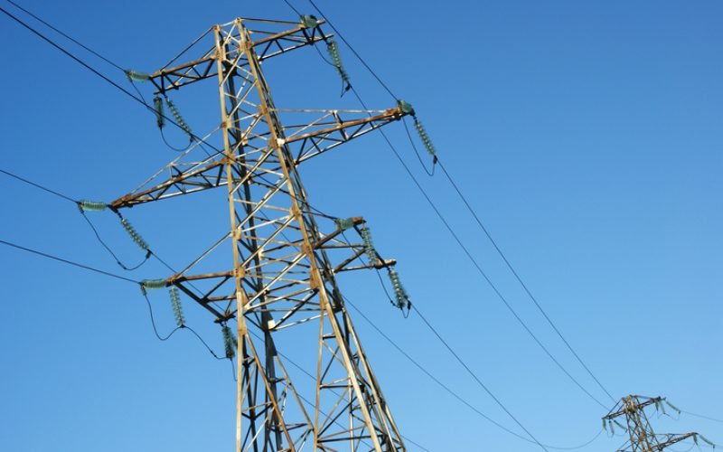 high-voltage line electrified  on background blue sky