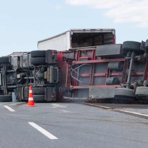 An overloaded and fast truck (TIR) overturned on an interurban road