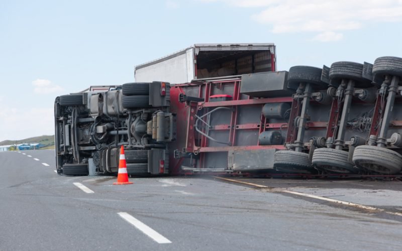 An overloaded and fast truck (TIR) overturned on an interurban road