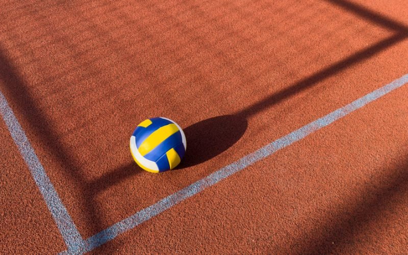 A volley ball is placed on a floor. High quality photo