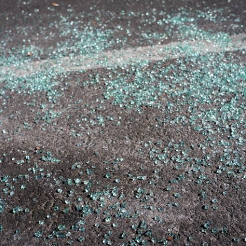 The consequences of a car accident. Small shards of glass on the asphalt