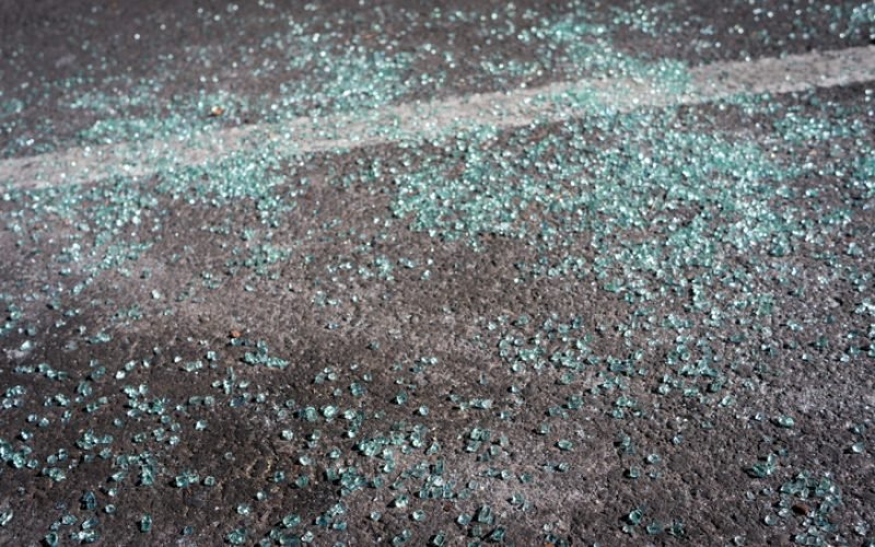 The consequences of a car accident. Small shards of glass on the asphalt